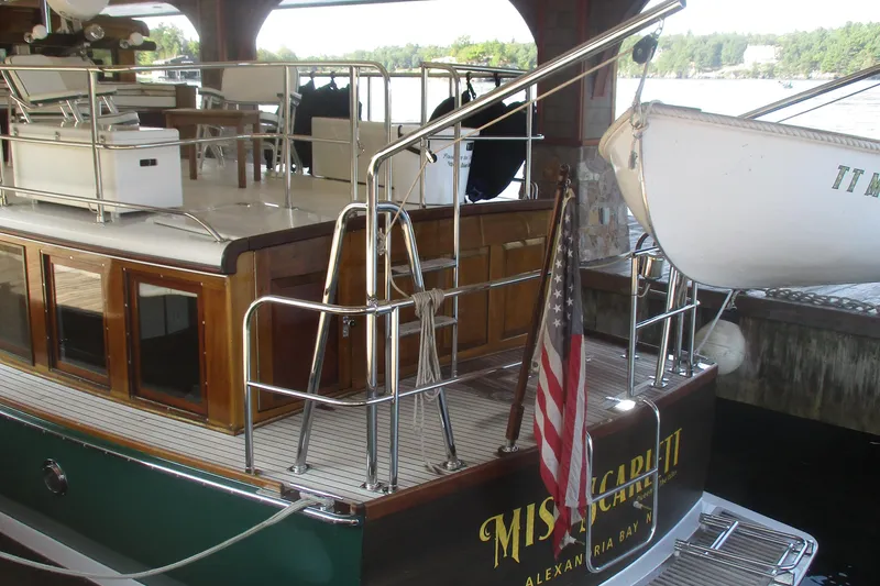 Slide: The Image of Vintage 1929 Gidley 52 Retro Modern Motor Yacht docked, featuring wooden details and American flag. - 28