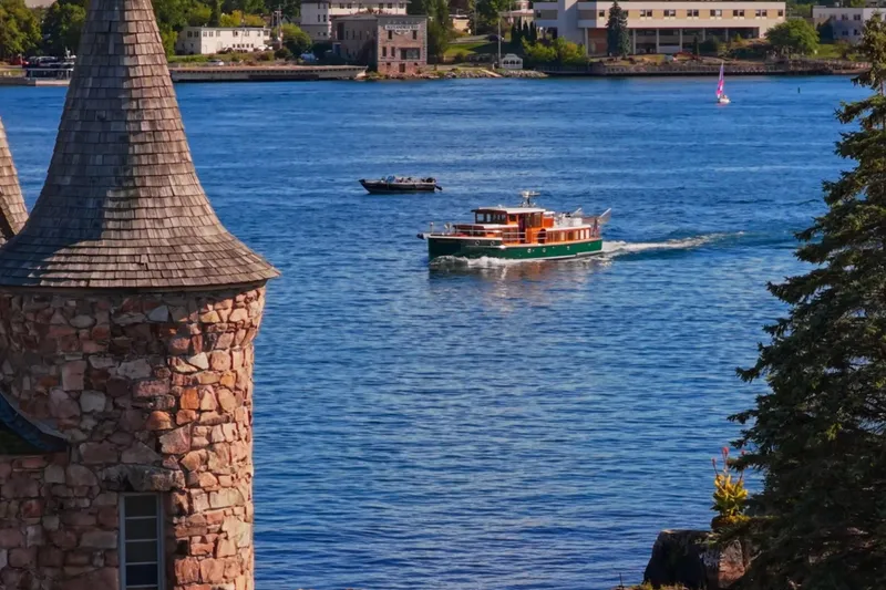 Slide: The Image of Vintage 1929 Gidley 52 Retro Modern Motor Yacht cruising near stone tower on scenic waterway. - 34