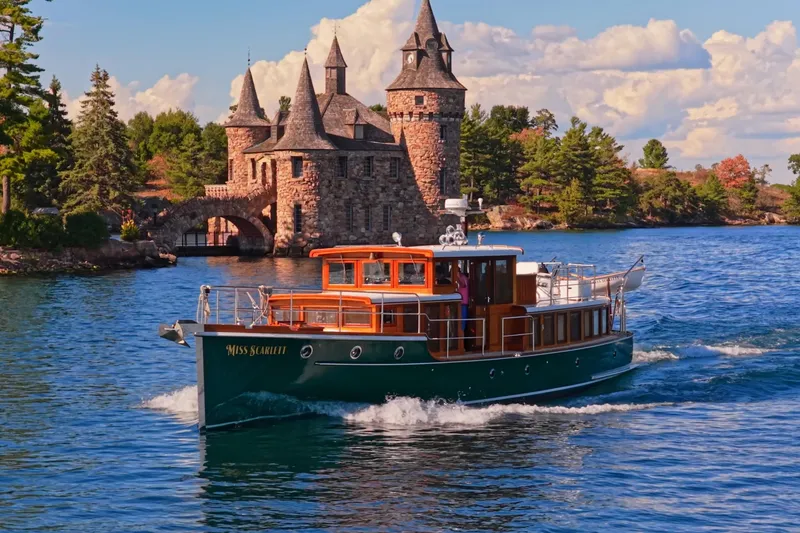 Slide: The Image of Vintage 1929 Gidley 52 Retro Modern Motor Yacht cruising near a historic stone castle. - 4