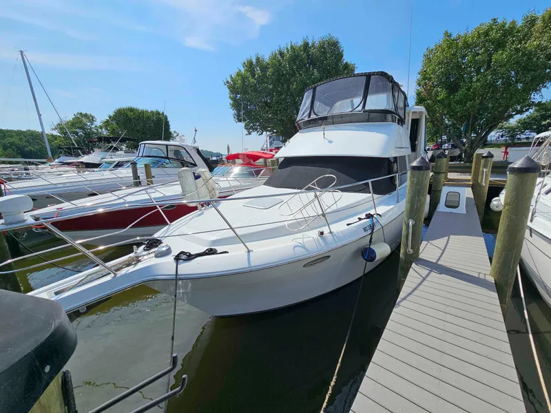 Slide: The Image of 2000 Carver 356 Aft Cabin Motor Yacht docked at marina under clear blue sky. - 1