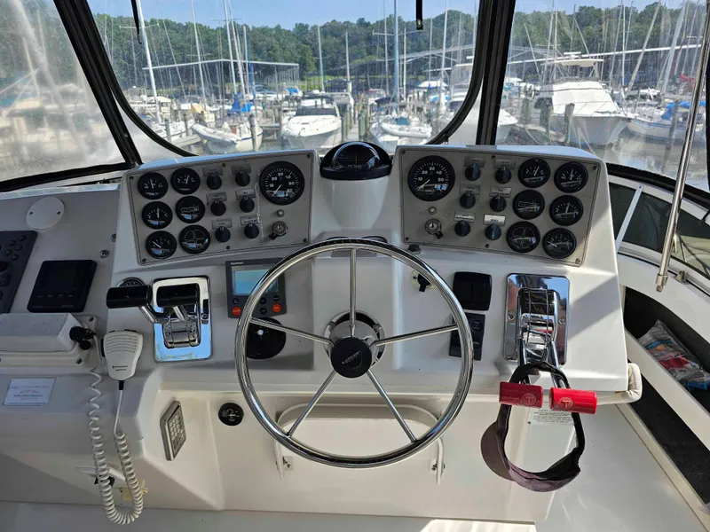 Slide: The Image of Helm of 2000 Carver 356 Aft Cabin Motor Yacht with steering wheel and control panels. - 13