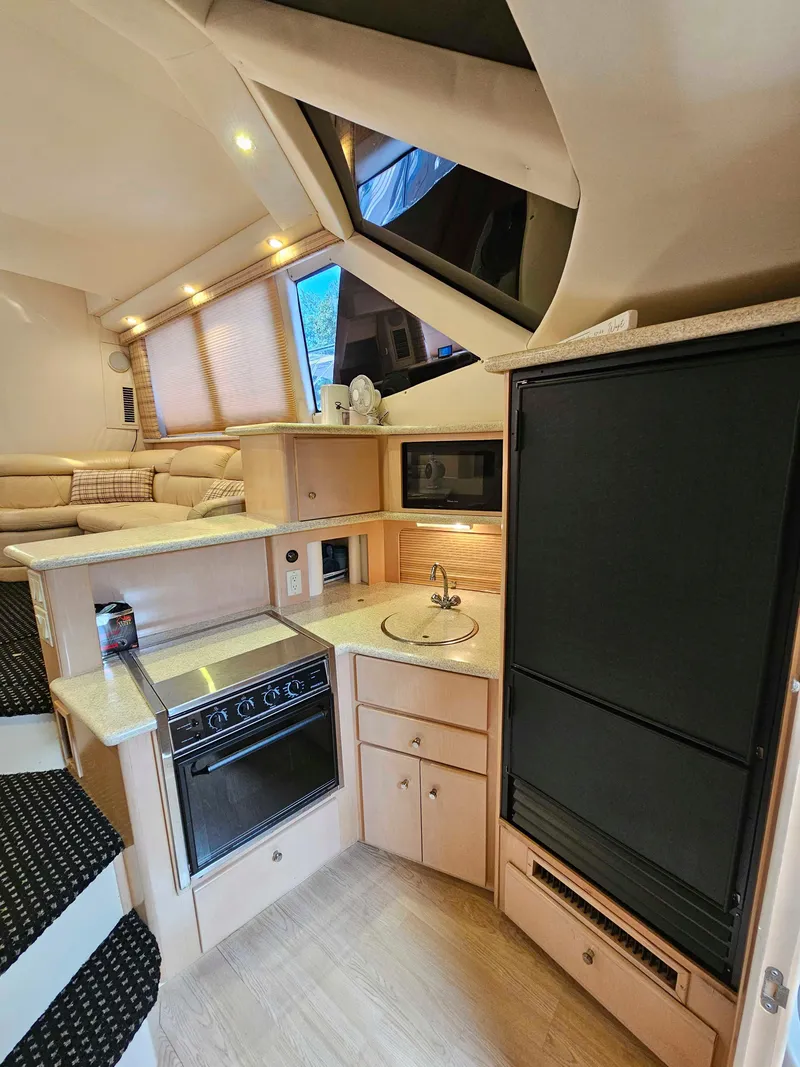 Slide: The Image of Interior of 2000 Carver 356 Aft Cabin Motor Yacht with kitchen and seating area. - 21