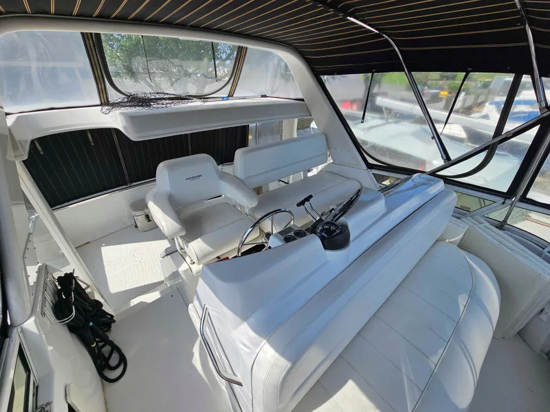 Slide: The Image of 2000 Carver 356 Aft Cabin Motor Yacht interior with helm and seating area. - 5