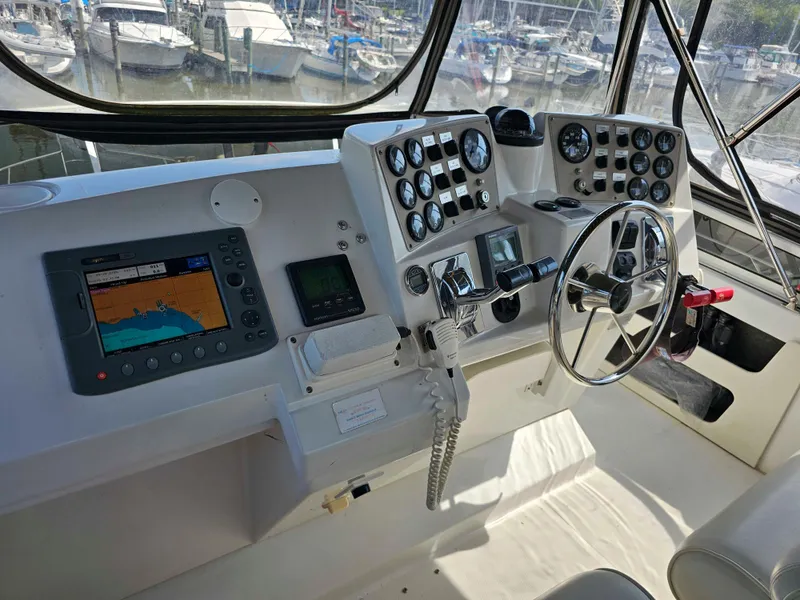 Slide: The Image of Control panel of a 2000 Carver 356 Aft Cabin Motor Yacht, featuring navigation and steering equipment. - 8