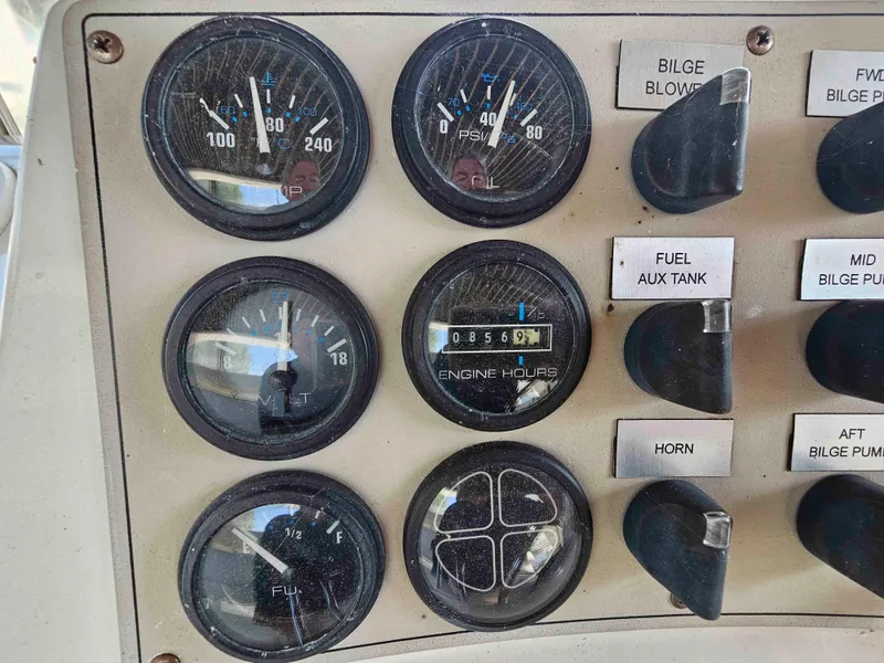 Slide: The Image of Control panel of a 2000 Carver 356 Aft Cabin Motor Yacht with gauges and switches. - 9