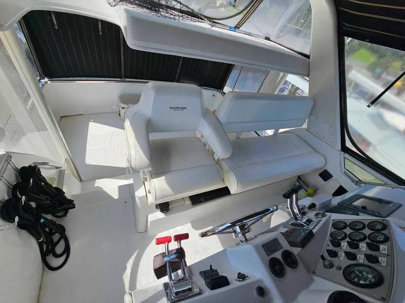 Slide: The Image of Interior helm of 2000 Carver 356 Aft Cabin Motor Yacht with white seating and control panel. - 10