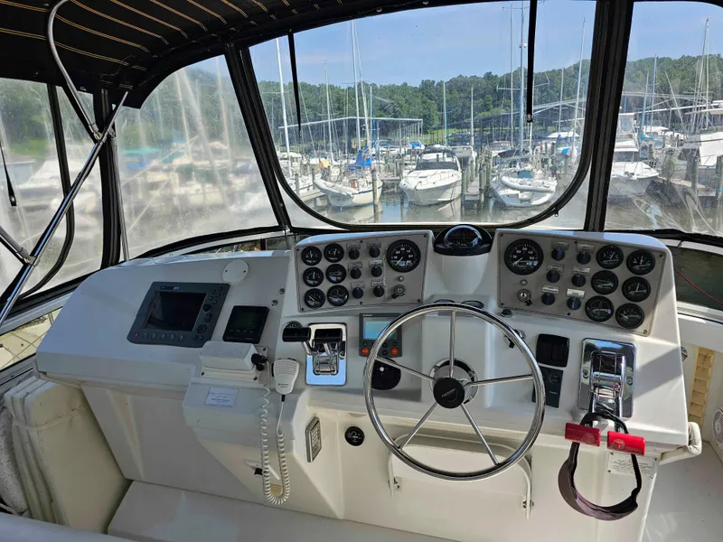 Slide: The Image of Helm of 2000 Carver 356 Aft Cabin Motor Yacht with marina view. - 12