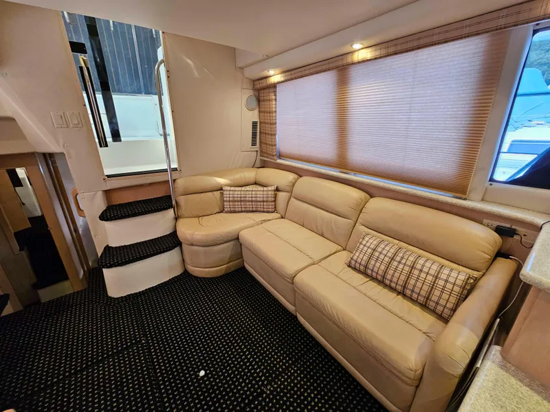 Slide: The Image of Luxurious interior of 2000 Carver 356 Aft Cabin Motor Yacht with beige leather seating. - 16