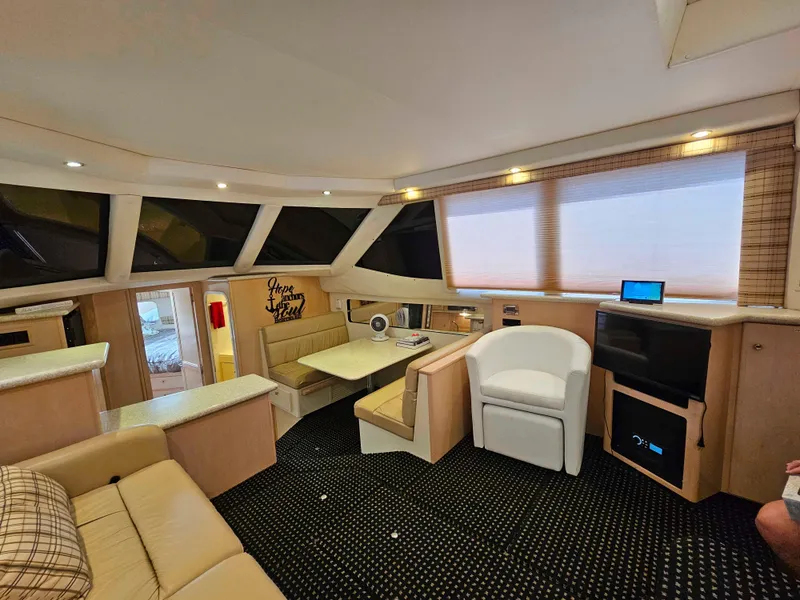 Slide: The Image of Interior of 2000 Carver 356 Aft Cabin Motor Yacht, featuring cozy seating and modern amenities. - 17