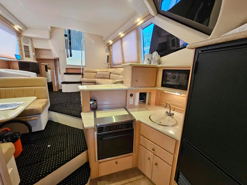 Slide: The Image of Luxurious interior of 2000 Carver 356 Aft Cabin Motor Yacht with modern kitchen amenities. - 20