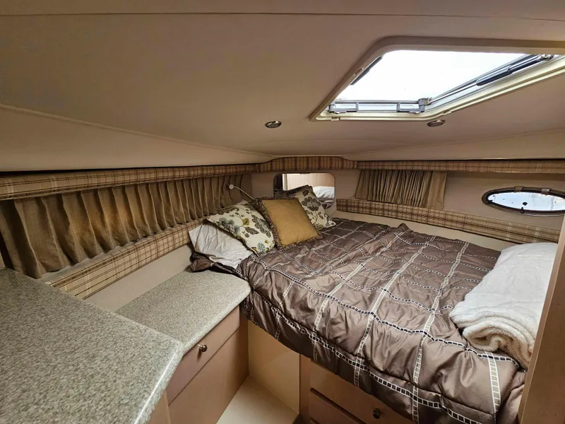 Slide: The Image of Cozy cabin interior of 2000 Carver 356 Aft Cabin Motor Yacht with bed and skylight. - 25