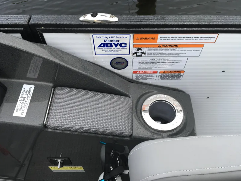 Slide: The Image of 2022 Crest Classic LX 240 boat interior with safety labels and cup holder. - 17