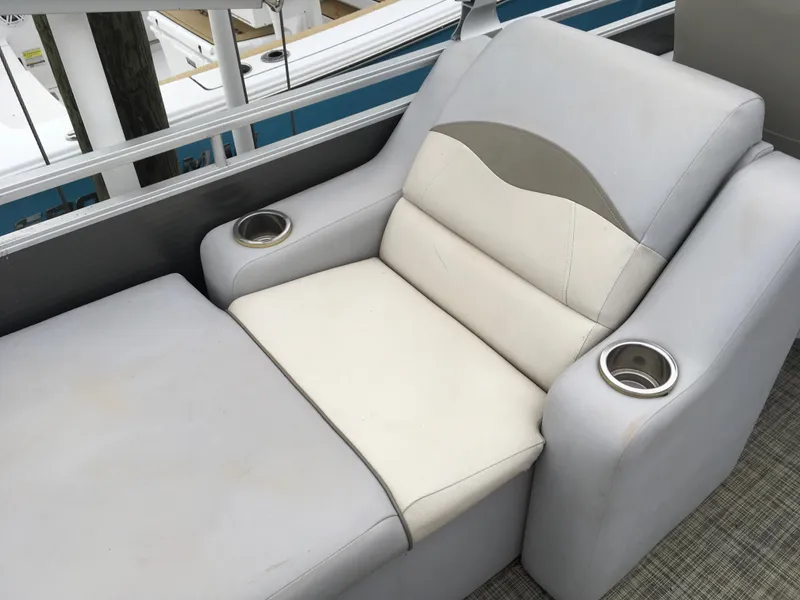 Slide: The Image of Luxurious seating on 2022 Crest Classic LX 240 pontoon boat with cup holders. - 28