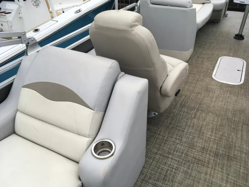 Slide: The Image of 2022 Crest Classic LX 240 boat interior with beige seating and cup holder. - 29