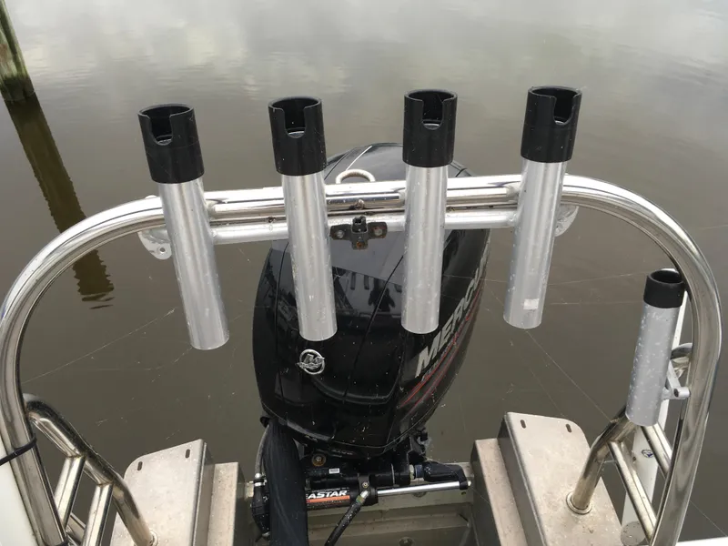 Slide: The Image of Boat motor and rod holders on 2022 Crest Classic LX 240, docked on calm water. - 30
