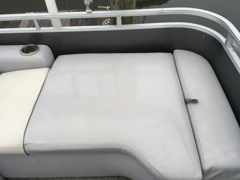 Slide: The Image of 2022 Crest Classic LX 240 boat seat with cup holder, gray upholstery, and water backdrop. - 31