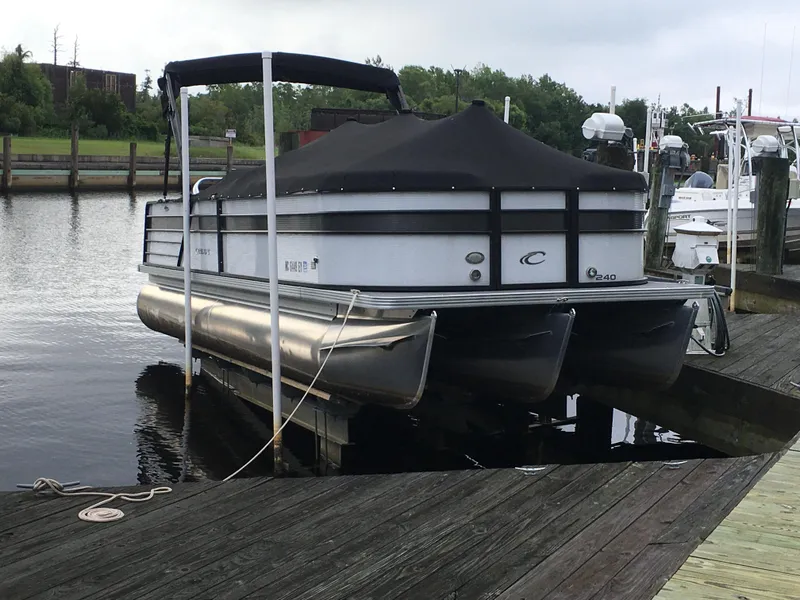 Slide: The Image of 2022 Crest Classic LX 240 pontoon boat docked at a marina. - 4
