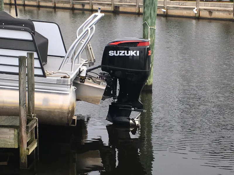 Slide: The Image of 2022 Crest Classic LX 240 pontoon boat with Suzuki outboard motor at dock. - 5