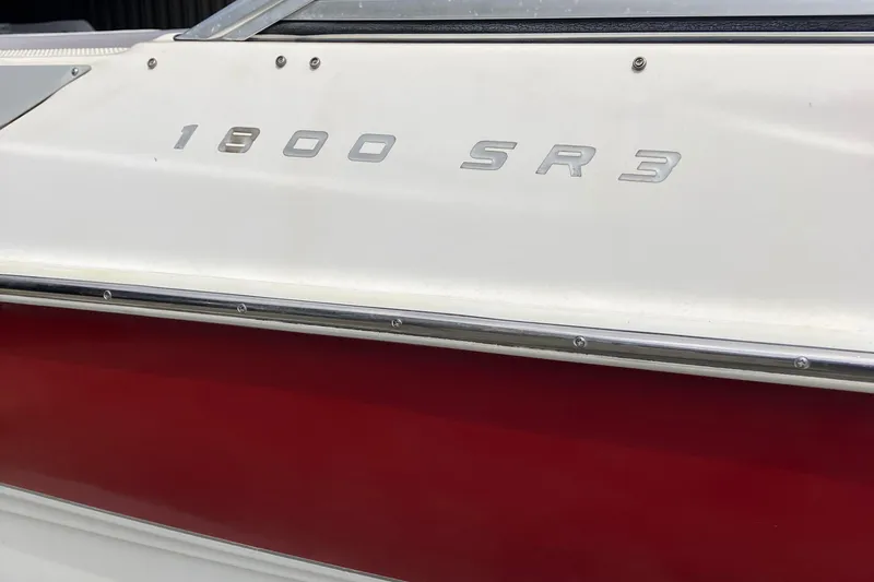 Slide: The Image of 2008 Maxum 1800SR boat with "1800 SR3" emblem on red and white hull. - 10