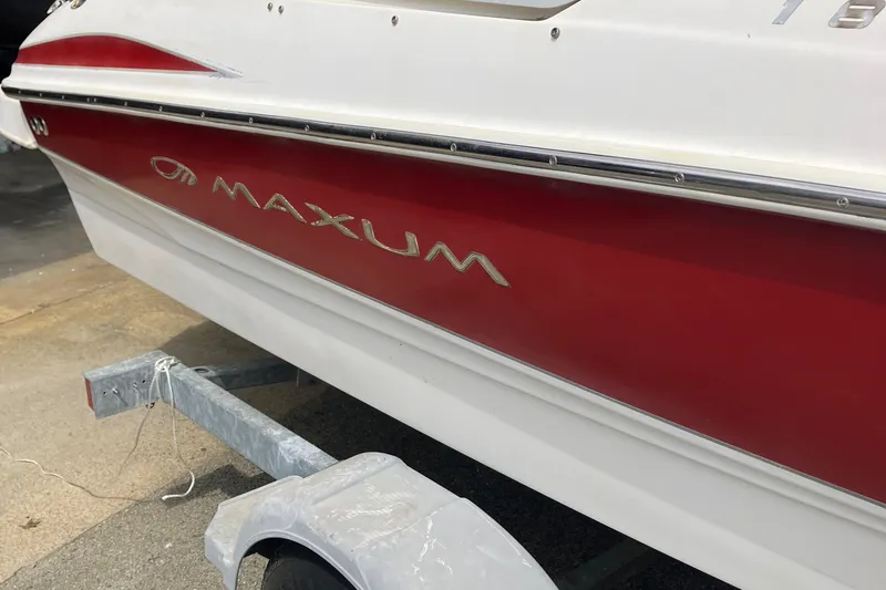 Slide: The Image of 2008 Maxum 1800SR boat with red and white exterior on a trailer. - 11