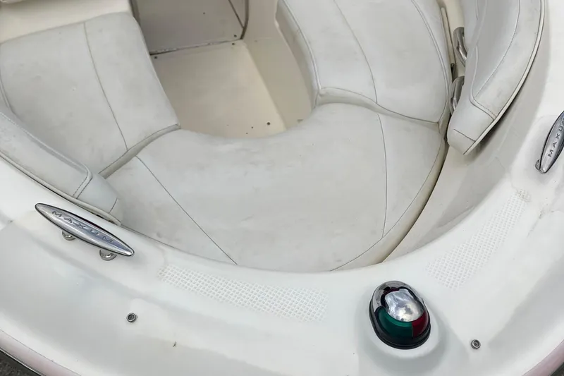 Slide: The Image of 2008 Maxum 1800SR boat interior with white seating and navigation light. - 13