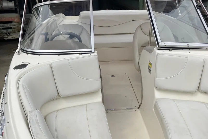 Slide: The Image of 2008 Maxum 1800SR boat interior with white seating and windshield. - 14