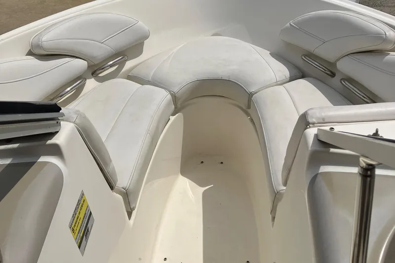 Slide: The Image of Interior of a 2008 Maxum 1800SR boat, featuring white seating and a speaker. - 16