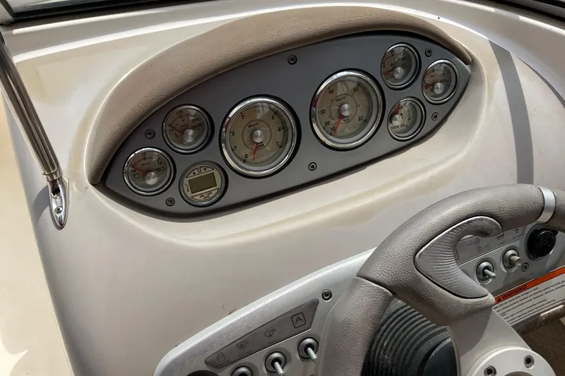 Slide: The Image of Dashboard of a 2008 Maxum 1800SR boat with gauges and steering wheel. - 18
