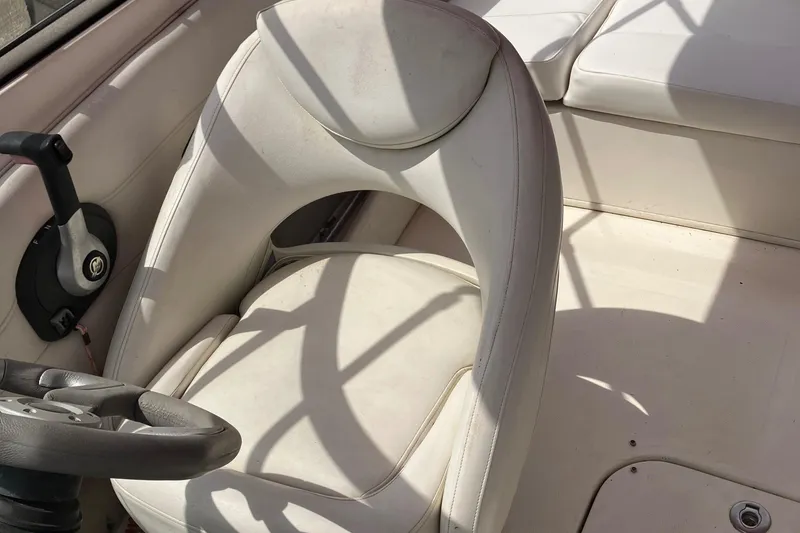 Slide: The Image of 2008 Maxum 1800SR boat interior with white seating and steering wheel. - 20
