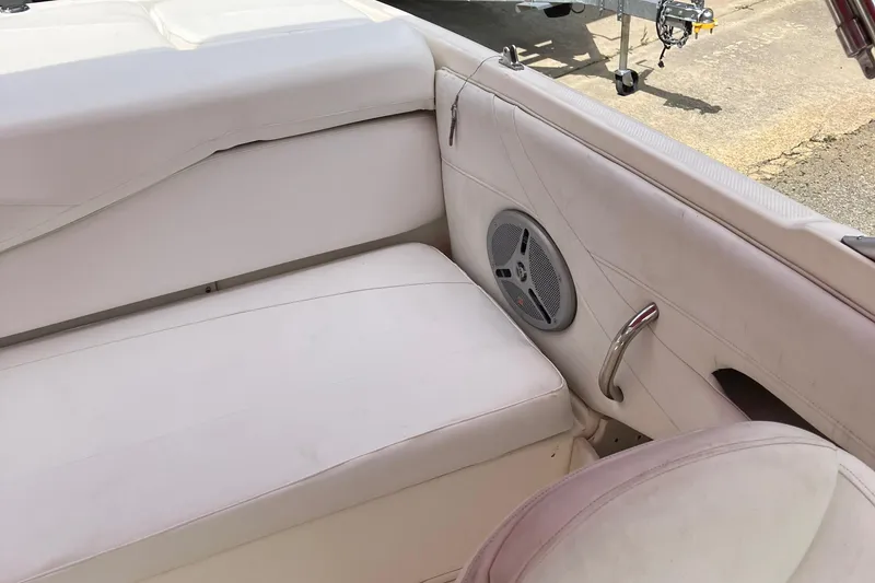 Slide: The Image of 2008 Maxum 1800SR boat interior with white seating and speaker. - 21