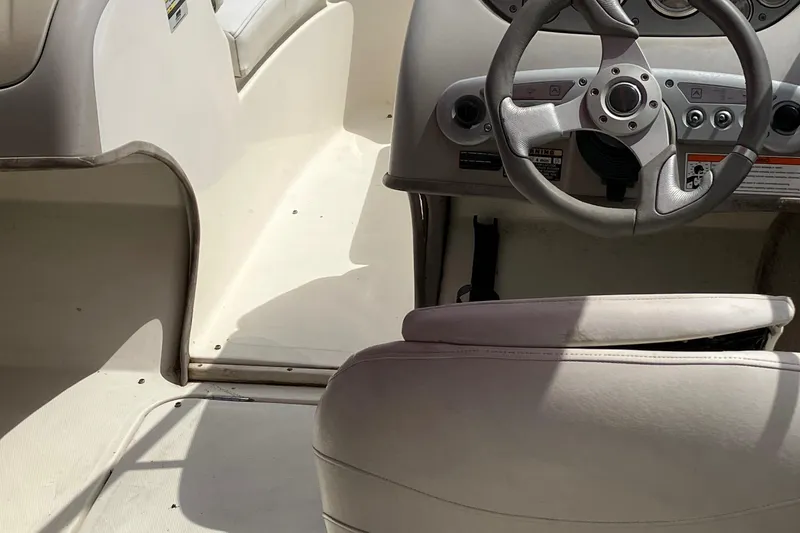 Slide: The Image of Interior of a 2008 Maxum 1800SR boat showing steering wheel and seating. - 25