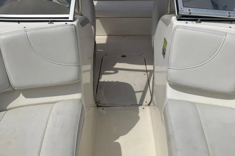 Slide: The Image of Interior of a 2008 Maxum 1800SR boat showing white seating and floor area. - 27