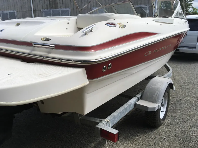 Slide: The Image of 2008 Maxum 1800SR boat on trailer, white and red design, parked outdoors. - 4