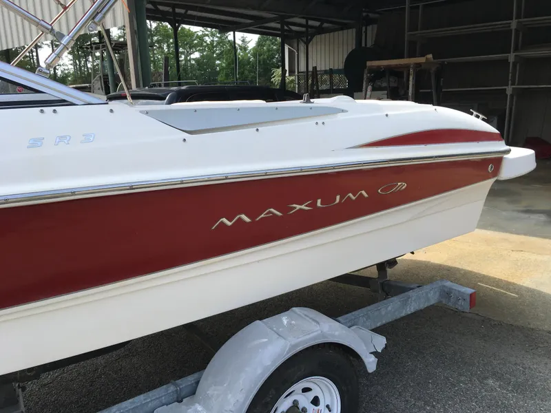 Slide: The Image of 2008 Maxum 1800SR boat on trailer, red and white design, parked in a covered area. - 7