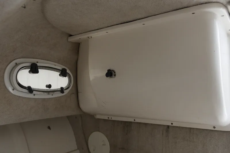 Slide: The Image of Interior cabin view of a 2003 Angler 2100WA boat, featuring a small window. - 14