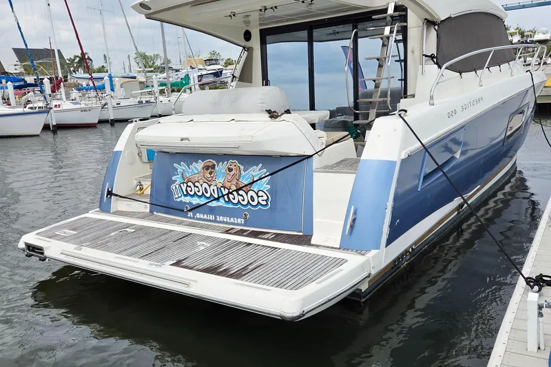 The Image of Prestige 450 yacht, 2015 model, docked at marina with custom graphics. - 1