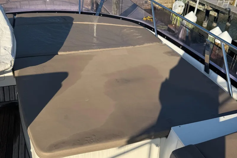 Slide: The Image of Sunlit deck of a 2015 Prestige 450 yacht with cushioned seating. - 4