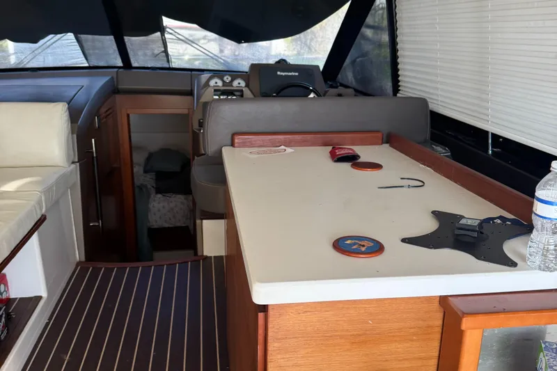 Slide: The Image of Interior of a 2015 Prestige 450 yacht with helm, table, and seating area. - 5