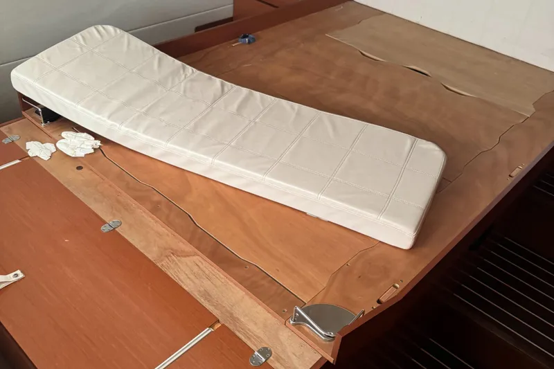 Slide: The Image of Interior of a 2015 Prestige 450 yacht with wooden surfaces and a white cushion. - 6