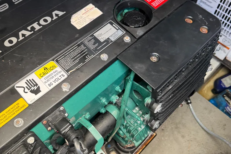 Slide: The Image of Engine compartment of a 2015 Prestige 450 with Volvo components and caution labels. - 9