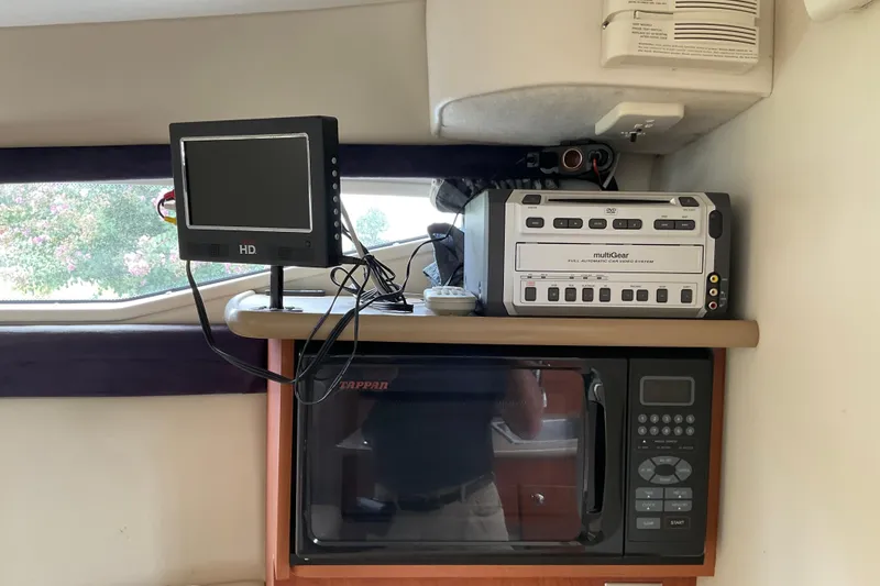 Slide: The Image of Interior of 2006 Bayliner 265 with microwave, DVD player, and HD monitor. - 7