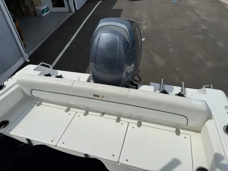 Slide: The Image of 2014 Sea Hunt Ultra 211 boat with Yamaha outboard motor, docked on pavement. - 12