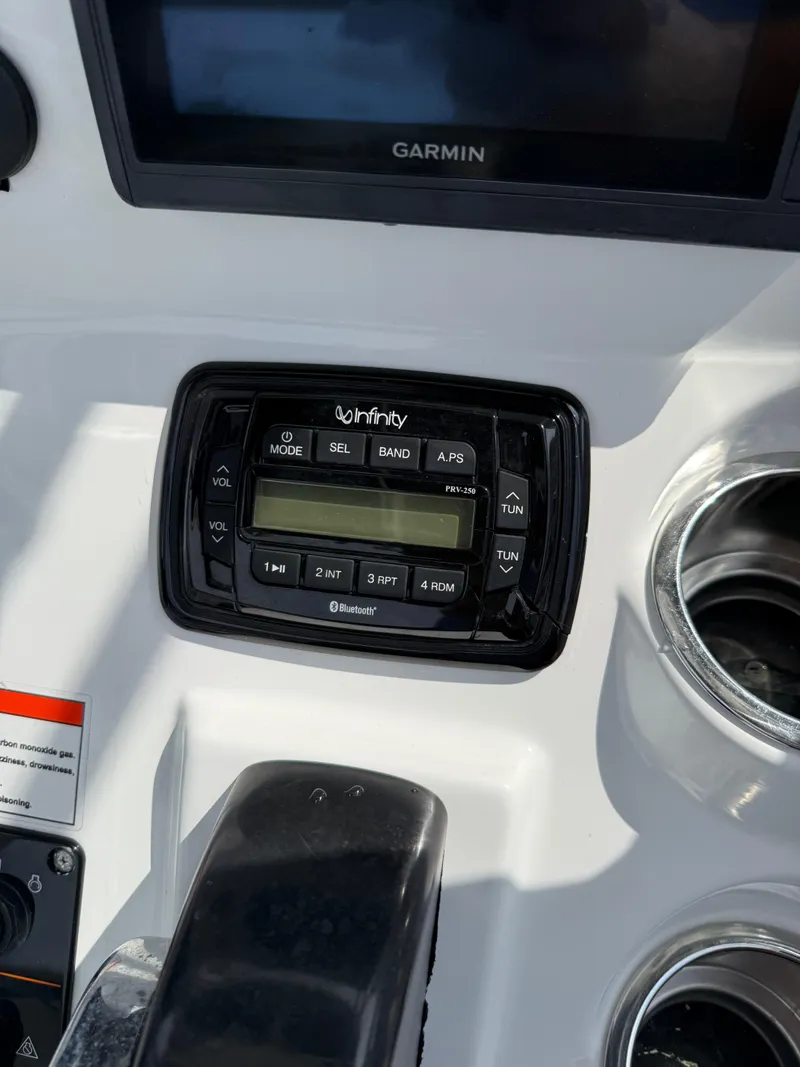 Slide: The Image of Infinity stereo system on 2014 Sea Hunt Ultra 211 boat dashboard with Garmin display. - 16