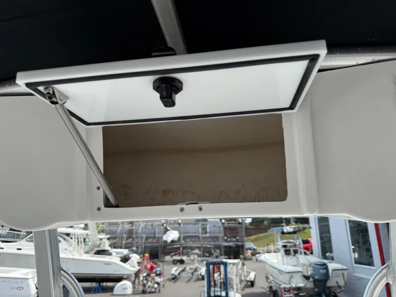Slide: The Image of Open storage compartment on a 2014 Sea Hunt Ultra 211 boat. - 17