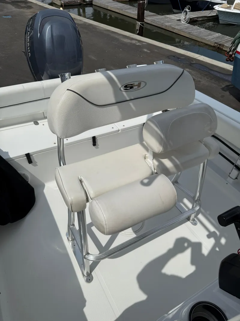 Slide: The Image of 2014 Sea Hunt Ultra 211 boat seating with white upholstery and chrome frame. - 18