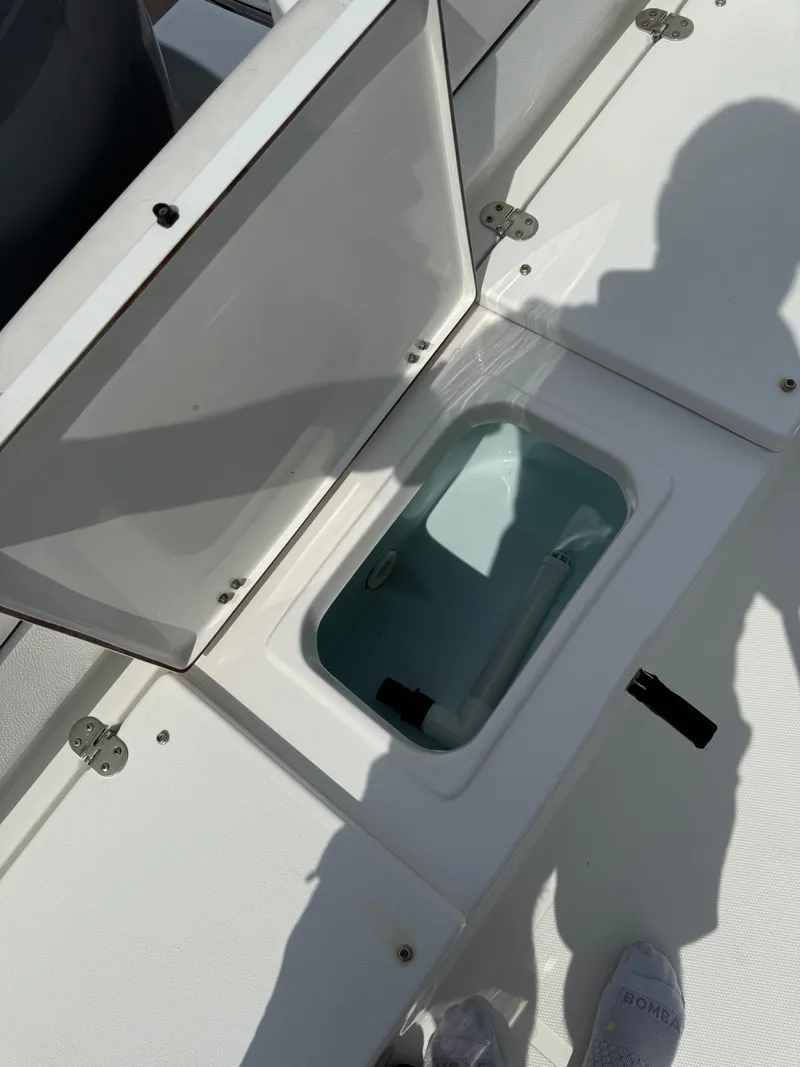 Slide: The Image of Open storage compartment on 2014 Sea Hunt Ultra 211 boat deck. - 19