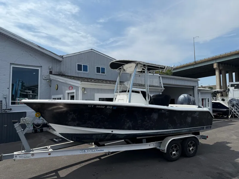 Slide: The Image of 2014 Sea Hunt Ultra 211 boat on trailer, parked outside a building. - 2