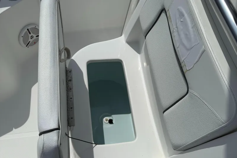 Slide: The Image of 2014 Sea Hunt Ultra 211 boat interior with seating and storage compartment. - 21