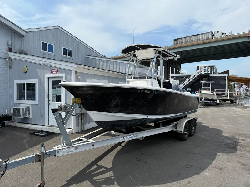 Slide: The Image of 2014 Sea Hunt Ultra 211 boat on trailer outside marina office. - 3