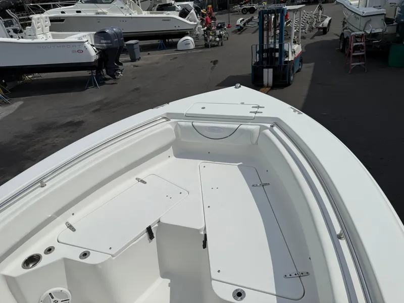 Slide: The Image of 2014 Sea Hunt Ultra 211 boat interior at a marina, showcasing seating and storage. - 5